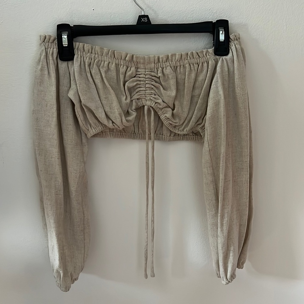 A super cute off the shoulder too. A tan color. Size small.